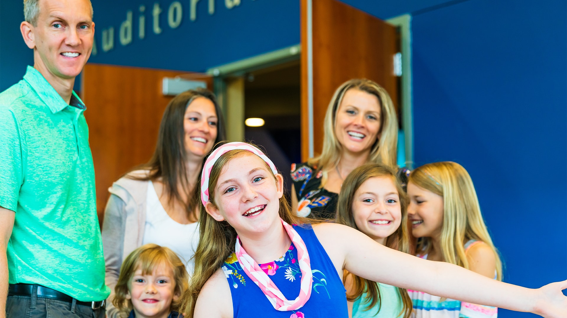 A family with kids smiling as they leave the Brookwood Church auditorium.